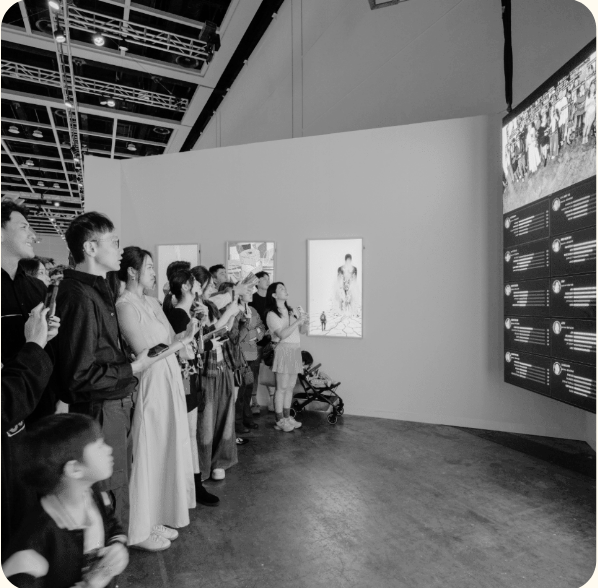 Visitors looking at digital artworks during an art fair