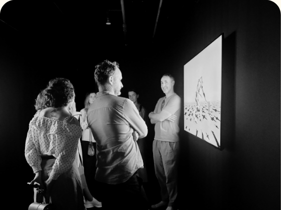 Collectors gathered in front of a digital artwork